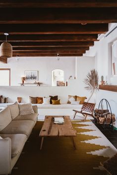 a living room filled with lots of furniture next to a fire place in a house