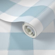 a blue and white checkered wallpaper with a rolled up roll on it's side