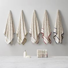 five towels hanging on the wall next to each other