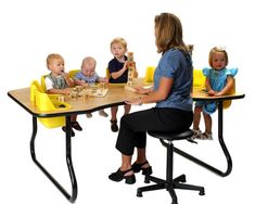 a woman sitting at a table with children