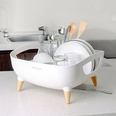 there is a dish rack with utensils in it