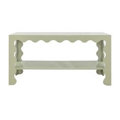 a white table with scalloped legs and a shelf on the top that is painted green