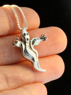 "Float into the \"Spirit\" of Halloween wearing this whimsical Ghost Charm. The Ghost is 1 inch high, solid sterling silver and detailed both front and back. All Marty Magic Charms and Pendants include an 18 inch (46cm) box chain. If you would prefer a different length of chain please feel free to contact me. All Marty Magic Jewelry is packaged in a beautiful box, embossed with the gold foil Marty Magic dragon logo. Perfect for any occasion. This item usually ships the same or next business day! Silver Themed Pendant Jewelry, Themed Silver Pendant Jewelry, Novelty Silver Necklaces With Charms, Silver Novelty Necklaces With Charms, Themed Sterling Silver Jewelry In Silver, Halloween Themed Silver Necklaces, Silver Halloween Charms Necklace, Sterling Silver Charms Necklace For Halloween, Silver Charms Necklace For Halloween