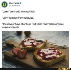 two pieces of bread with jam on them and strawberries in the middle, sitting on a cutting board