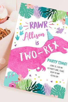 a pink dinosaur birthday party card next to some cupcakes and muffins