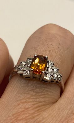 Unusual cut of citrine and surrounded by white sapphires in 925 sterling silver setting Handmade Size 7 Can be resized, my jeweler charges $10-$20 All rings are shipped in a nice gift box. Check out our over a THOUSAND great reviews Engraving is $4 per letter and is not always perfect depending on the piece. It can take a few days if the jeweler is busy. This is payable to Paypal Judithsltd@gmail.com Classic Topaz Birthstone Ring For Gift, Elegant Orange Sapphire Ring As Gift, Elegant Orange Sapphire Ring Gift, Classic Topaz Rings Perfect For Gifts, Classic Topaz Rings For Gift, Orange Topaz Ring With Accent Stones For Gift, Orange Topaz Ring With Accent Stones As Gift, Orange Topaz Ring With Center Stone For Gift, Orange Topaz Ring With Center Stone As Gift