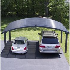 two cars are parked in the parking lot under an awning that covers them from sun glares