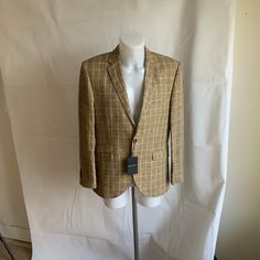 In immaculate unworn condition, as new, with tags, 100% linen beige and black plaid jacket by Brook Taverner Signature. Size 38S. Polyester and viscose satin lining. Two button front, double vented back. Three front pockets with flaps, plus 1 breast pocket. Two inside pockets plus pen pocket. 4 button cuffs. Lapel with single button hole. Superb linen fabric. High quality garment from a prestigious label. Armpit to armpit 21 in , back length 29 in, shoulder width 18 in, sleeve length 25 in. Fair Fitted Plaid Blazer For Spring, Tailored Plaid Tweed Jacket For Spring, Tailored Plaid Blazer For Spring, Spring Single Breasted Plaid Blazer, Plaid Formal Outerwear For Spring, Plaid Linen Blazer For Business, Spring Fitted Plaid Blazer, Plaid Notch Lapel Tweed Jacket For Spring, Fitted Plaid Tweed Jacket With Single Button