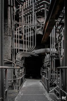 the inside of an industrial building with metal pipes