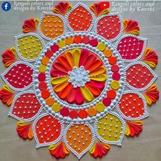 this is an image of a colorful doily made with paper and beads on the table