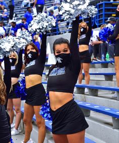 the cheerleaders are all dressed in black and blue