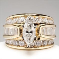 an image of a wedding ring set with two bands and three pear shaped diamonds on each band