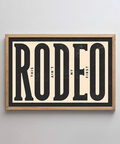 a wooden sign that says rodeo with the word rodeo in black and white on it