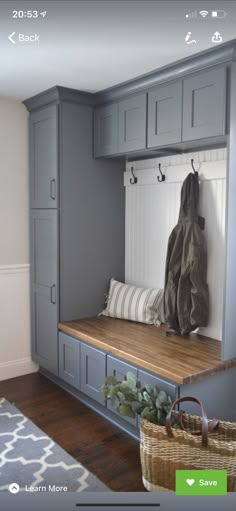 a bench that is in the middle of a room with gray cabinets and benches on it