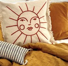 a pillow with a sun drawn on it