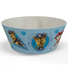 a blue paw patrol bowl with two dogs on the front and one is wearing a hat