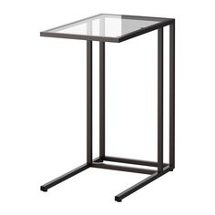 a glass and metal side table on a white background