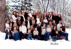 a large group of people posing for a photo in the snow