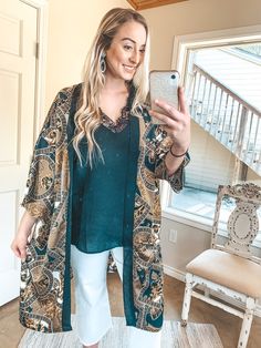 This beautiful kimono is one sure way of staying in style! This classic look is perfect for all occasions, such as work, weddings, and cruises! This kimono includes a flowy 3/4 sleeve and body, a beautiful baroque print on a black background, and a black trim. Pair this with gold jewelry and you'll be set. Josie is a size 6 wearing the O/S. Abby is a size 14 wearing the O/S. Size Suggestions: One Size: 2-20 Fabric Content: 100% Polyester Care Instructions: Hand wash, cold. Do not bleach. Hang to Elegant V-neck Robe For Vacation, Elegant Flowy Wrap Kimono, Elegant V-neck Kimono For Vacation, Elegant Long Sleeve Robe For Vacation, Elegant Kimono Sleeve Robe For Vacation, Elegant Vacation Robe With Kimono Sleeves, Elegant Summer Kimono For Brunch, Elegant Robe With Kimono Sleeves For Vacation, Fall Brunch Kimono With Kimono Sleeves