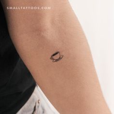 a small coffee cup tattoo on the arm