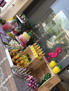 a table filled with lots of different types of desserts and candies on sticks