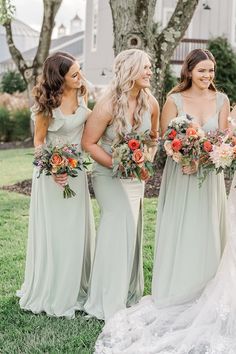 the bridesmaids are all dressed in mint green dresses and holding bouquets together