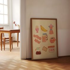 an art work is displayed on the wall next to a table and chairs in a room