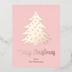 a pink christmas card with a gold foil tree on the front and merry christmas from the persons below