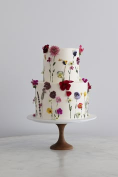 a three tiered cake with flowers on it