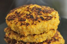 three patties are stacked on top of each other in front of a frying pan