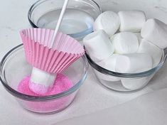 marshmallows and pink powder in bowls on a counter top, one with a toothpick sticking out of it