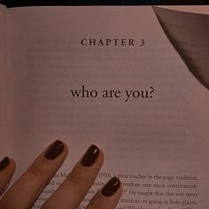 a woman's hand holding onto an open book with the words, who are you?