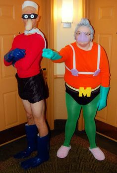 two people in costumes are standing next to each other and one is wearing an orange shirt