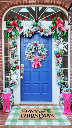 a blue front door decorated with christmas decorations