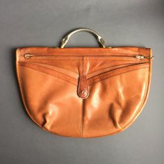 "80s \"Groselj\" famous slovenian designer Handbag ,retro Orange Brown Purse Deep Rich Tan Cognac Leather, Metal Zipper, Womens fashion Bag great vintage condition with scratches on the back, size: 40 x 27 cm Please contact me for any information, especially for custom shipping. similar items you can find under: https://www.etsy.com/shop/RosaBoutiqueStudio?ref=hdr_shop_menu&section_id=20946083 and you can always look into my shop for all the others: https://www.etsy.com/shop/RosaBoutiqueStudio" Brown Purse, Retro Mode, Brown Purses, Women Bags Fashion, Designer Handbag, Metal Zipper, Orange Brown, Cognac, Purses And Handbags