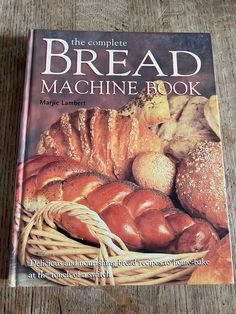 the complete bread machine book on a wooden table