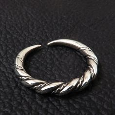 Replica of an archeological artifact from Gotland, Sweden. Made of sterling (925) silver. The original artifact is dated 9th-11th century A.D. The ring is 3.5mm (0.14 inch) thick. It can be adjusted between sizes 7 and 11 US scale (15 and 25 european scale). Hand Forged Silver Medieval Jewelry, Hand Forged Medieval Silver Jewelry, Medieval Sterling Silver Jewelry In Antique Silver, Medieval Sterling Silver Engraved Rings, Medieval Engraved Sterling Silver Rings, Medieval Hand Forged Sterling Silver Jewelry, Medieval Style Hallmarked Silver Jewelry, Viking Style Sterling Silver Ring, Medieval Sterling Silver Rings