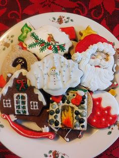 a white plate topped with lots of decorated cookies