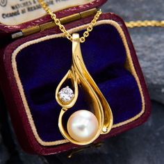 This custom-made pendant was made using the lost-wax method and showcases a round cultured pearl inside an open teardrop shape design, accented with a round brilliant cut diamond to one side. The pendant and chain are both 14k yellow gold, and the pendant hangs from an 18 inch cable chain with jump rings so it can also be worn at 16 and 17 inches long. Antique Engagement Rings Sapphire, Estate Jewelry Rings, Wedding Ring Diamond Band, Antique Engagement Rings, Pearl Pendant Necklace, European Cut Diamonds, Lost Wax, Sapphire Engagement, Engagement Rings Sapphire