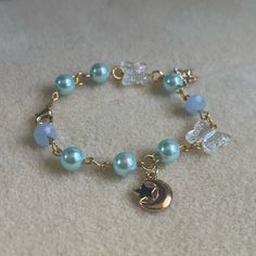 - One Of A Kind Beaded Charm Bracelet - Featuring Light Blue Pearl Beads, Clear White Butterfly Beads, A Gold Metal Crescent Moon Charm, A Star Charm That Says “Just For You,” And Gold Metal Links - Gold Colored Hardware - Clasps Closed. No Stretch. - Size/ Circumference Is 6.5” (See Picture) - Handmade (By Myself). Perfect To Treat Yourself Or To Give As A Gift! **Add 2 Jewelry Items Marked “2 For $20” To Your Bundle And I Will Send You An Offer For $20** Check Out The “Boutique” Tab In My Clos Cute Blue Bracelets For Party, Diy Charm Bracelet Ideas, Star Cartilage Earring, Keychain Designs, Star Charm Bracelet, Turquoise Stone Bracelet, Butterfly Moon, Girly Bracelets, Butterfly Beads