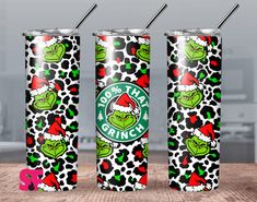 two starbucks christmas cans with the grin face on them, both decorated in black and white polka dots