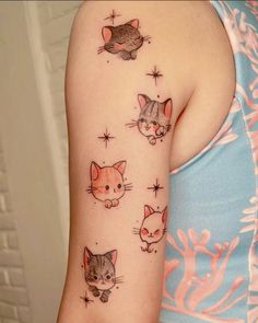 a woman's arm with cats and stars on it