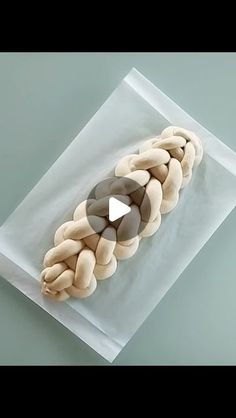 a plastic bag filled with donuts on top of a white countertop next to a green wall