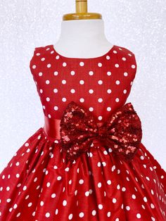 Hand stitched together with the upmost care, this dress is perfect for any occasion: birthdays, pageants, photoshoots, and holiday parties! The comfortably soft polka dot dress is made out of cotton material; The bodice is sleeveless with a zipper in the back. The dress comes with a detachable ribbon sash and mini sequin small bow to add sparkle. Knee length skirt made out of cotton polka dot fabric. Under the skirt is one layer of lining with crinoline attached to add extra puffiness. *Mannequi Red Dresses For Kids, Newborn Flower, Christmas Pageant, Red Polka Dot Dress, Under The Skirt, Polka Dot Fabric, Christmas Dress, Retro Chic, Dot Dress