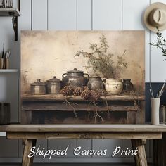 a table topped with pots and pans next to a vase filled with pine cones