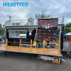 the food truck is parked on the side of the road and has a sign advertising it