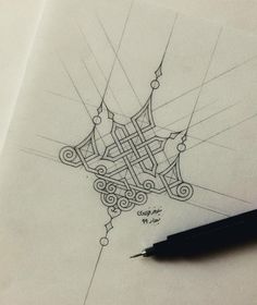 a drawing of a design on paper with a pen next to it and the image is drawn