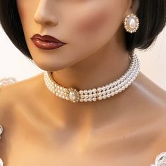 An elegant versatile Three-strand pearl choker comes with a matching pair of stud earrings. This set is a lovely addition to your modern, classic, or vintage-inspired wedding. Bridal jewelry set, Bridal choker necklace earrings, Wedding choker, white Victorian pearl jewelry set, bridesmaid jewelry, choker set, evening jewelry, party jewelry , vintage inspired jewelry • Color : White, Silver, Clear • Theme : Pearl • Necklace Size : 11" to 14" adjustable • Decor Size : 1" L • Bracelet Size : 1" H Luxury Pearl Necklace, Luxury Pearl Jewelry, Bride Pearl Necklace, Bridal Choker Necklace, 1940s Jewelry, Pearl Jewelry Set, White Victorian, Evening Jewelry, Bridal Choker