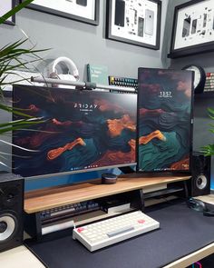 two computer monitors sitting on top of a desk