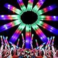 a large group of people standing in front of a colorful light up starburst